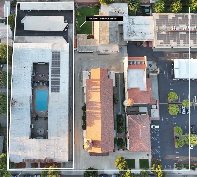 An aerial view of a parking lot and swimming pool.