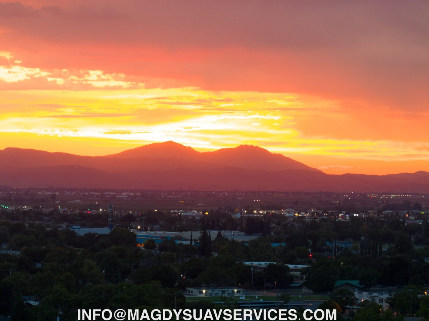 A sunset over the mountains in the distance.