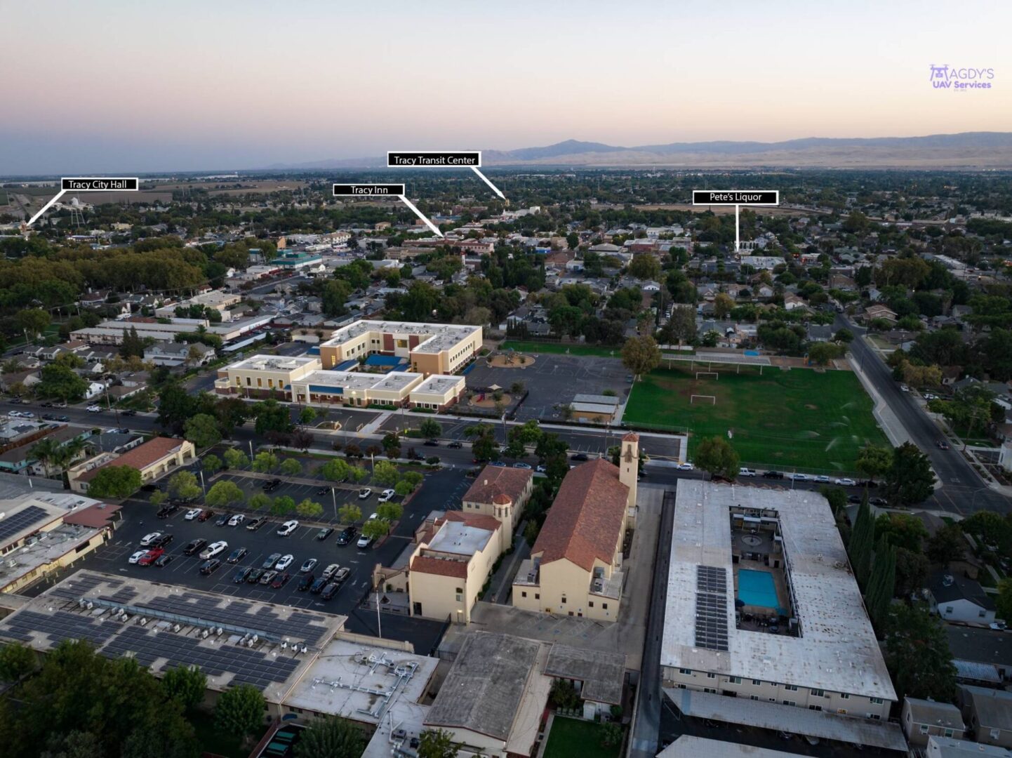 A bird 's eye view of an urban area with buildings and parking lots.